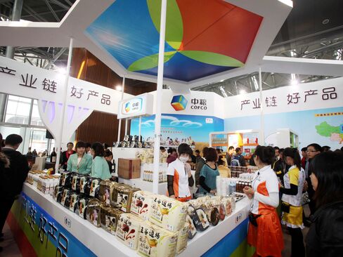 People visit a COFCO stand during an exhibition in Tianjin, China.