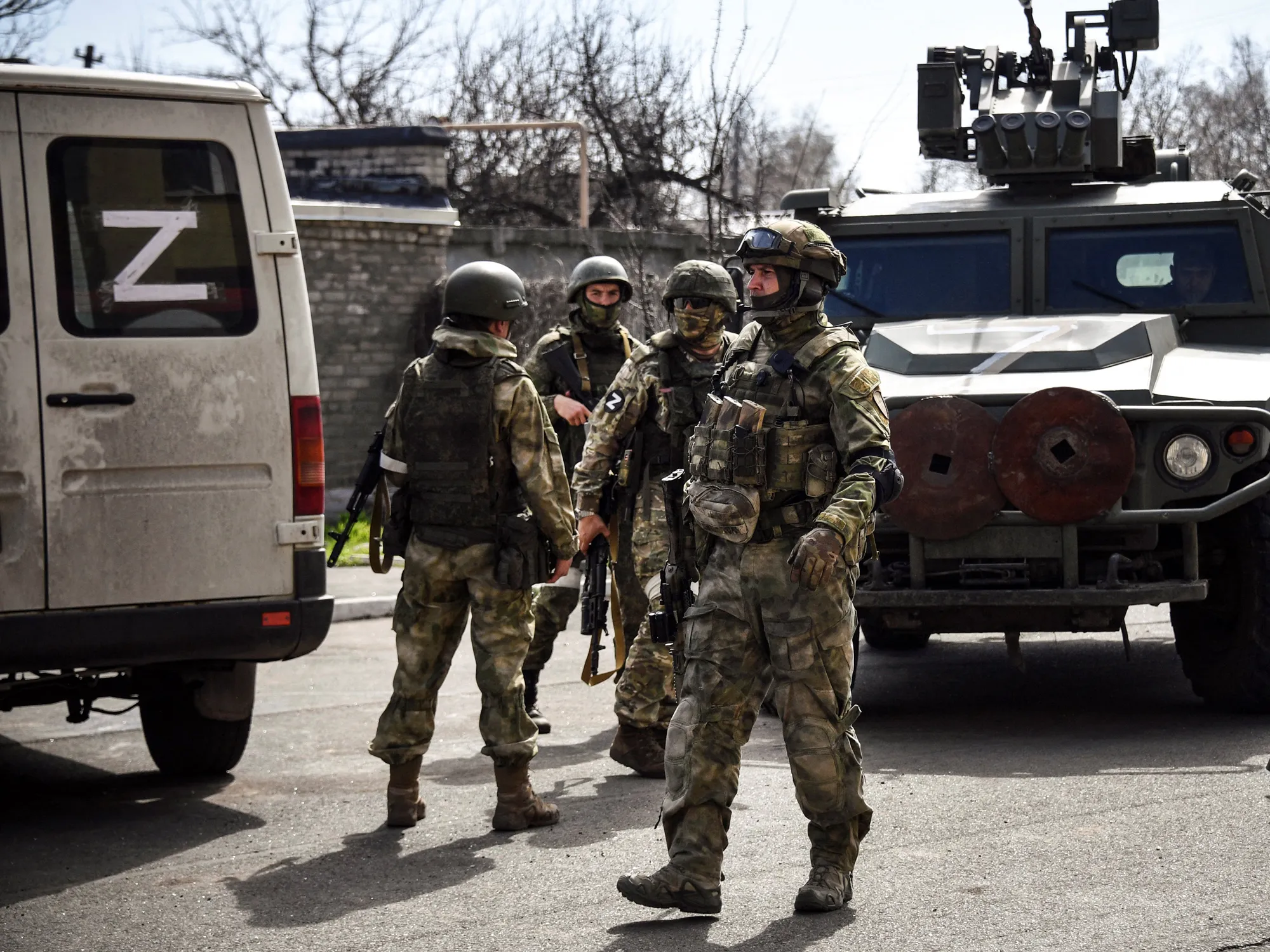 Russian soldiers patrol a street in Volnovakha, Ukraine, in April.