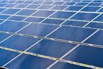 Solar panels stand at a solar farm, July 21, 2017.