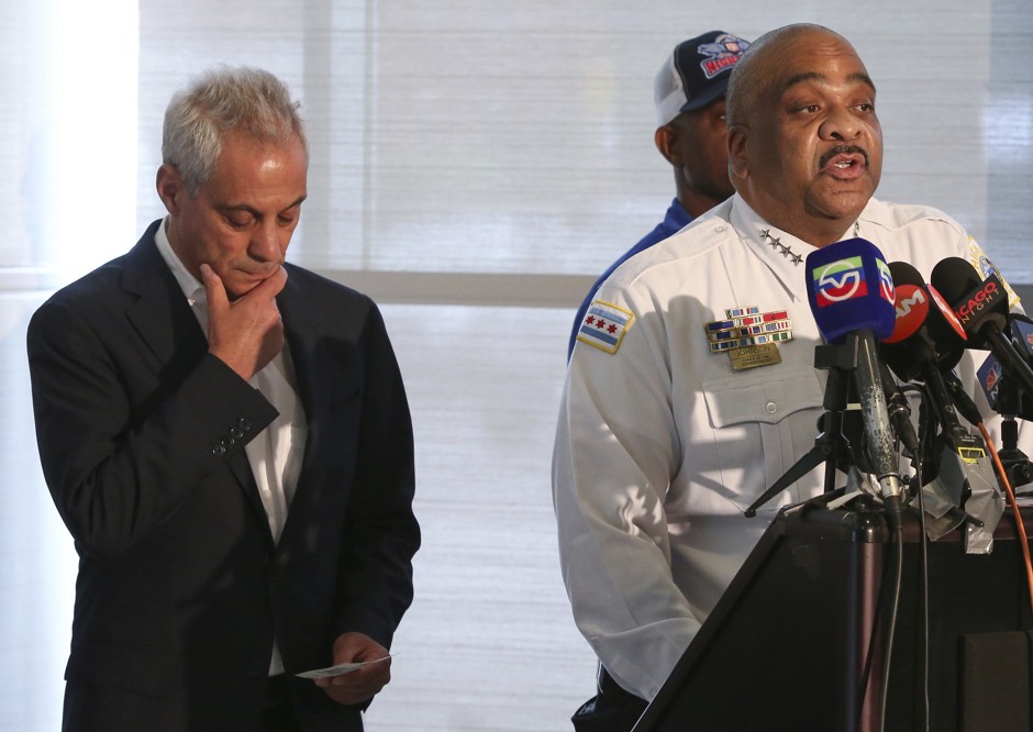 Rahm Emanuel stands behind Eddie T. Johnson of the Chicago Police Department as he addresses the news media.
