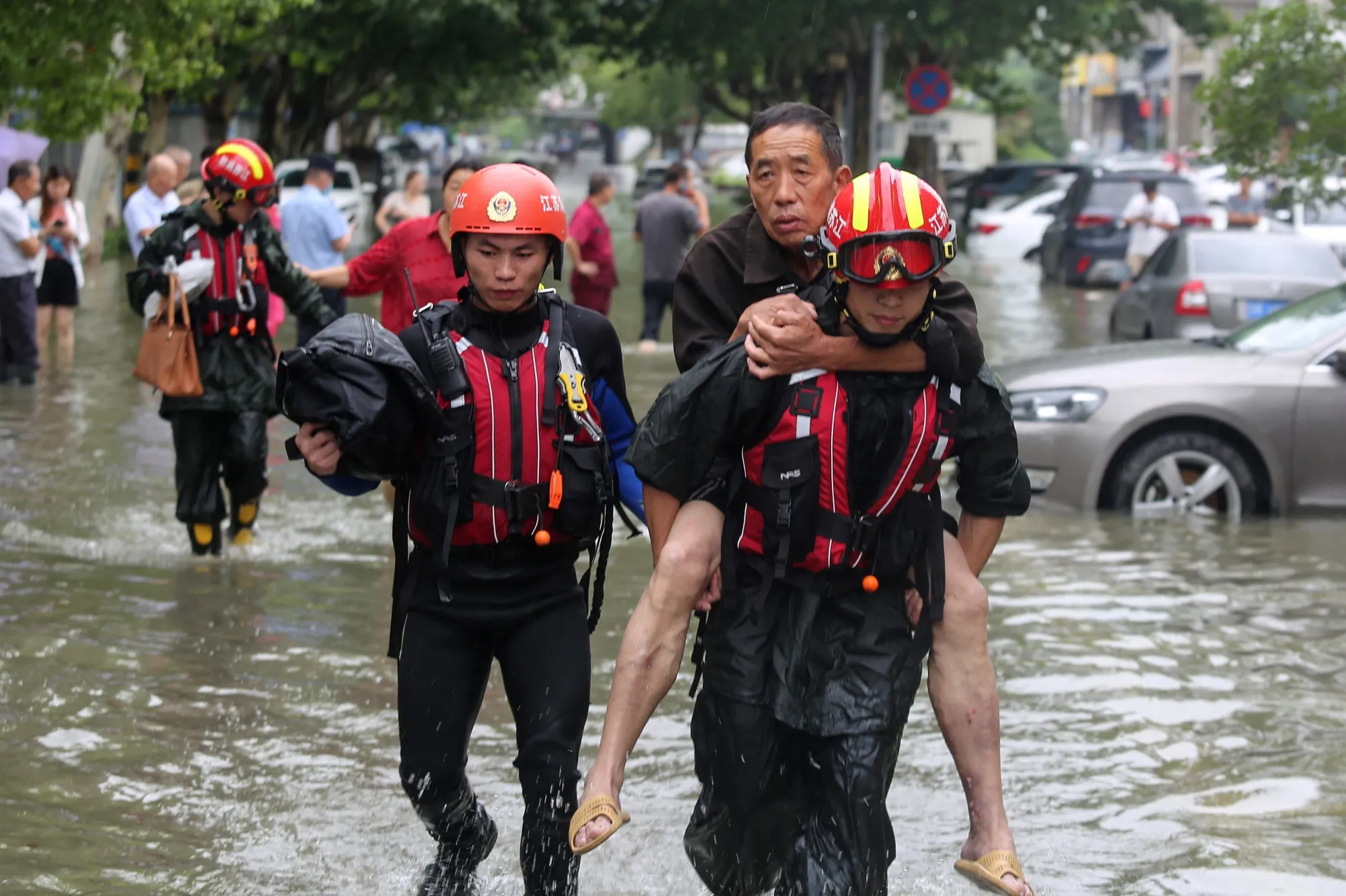 Rescuers evacuate residents from a flooded area in Yangzhou, in China's eastern Jiangsu province, on July 28.