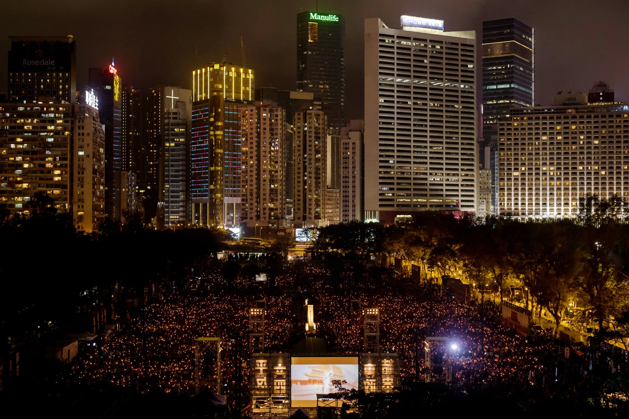 Demonstrators attend a candlelight vigil at Victoria Park in Hong Kong on June 4, 2017.