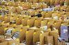 An employee moves between stacked boxes and parcels ahead of shipping from the warehouse of an Amazon.com Inc. fulfillment center in Koblenz, Germany.