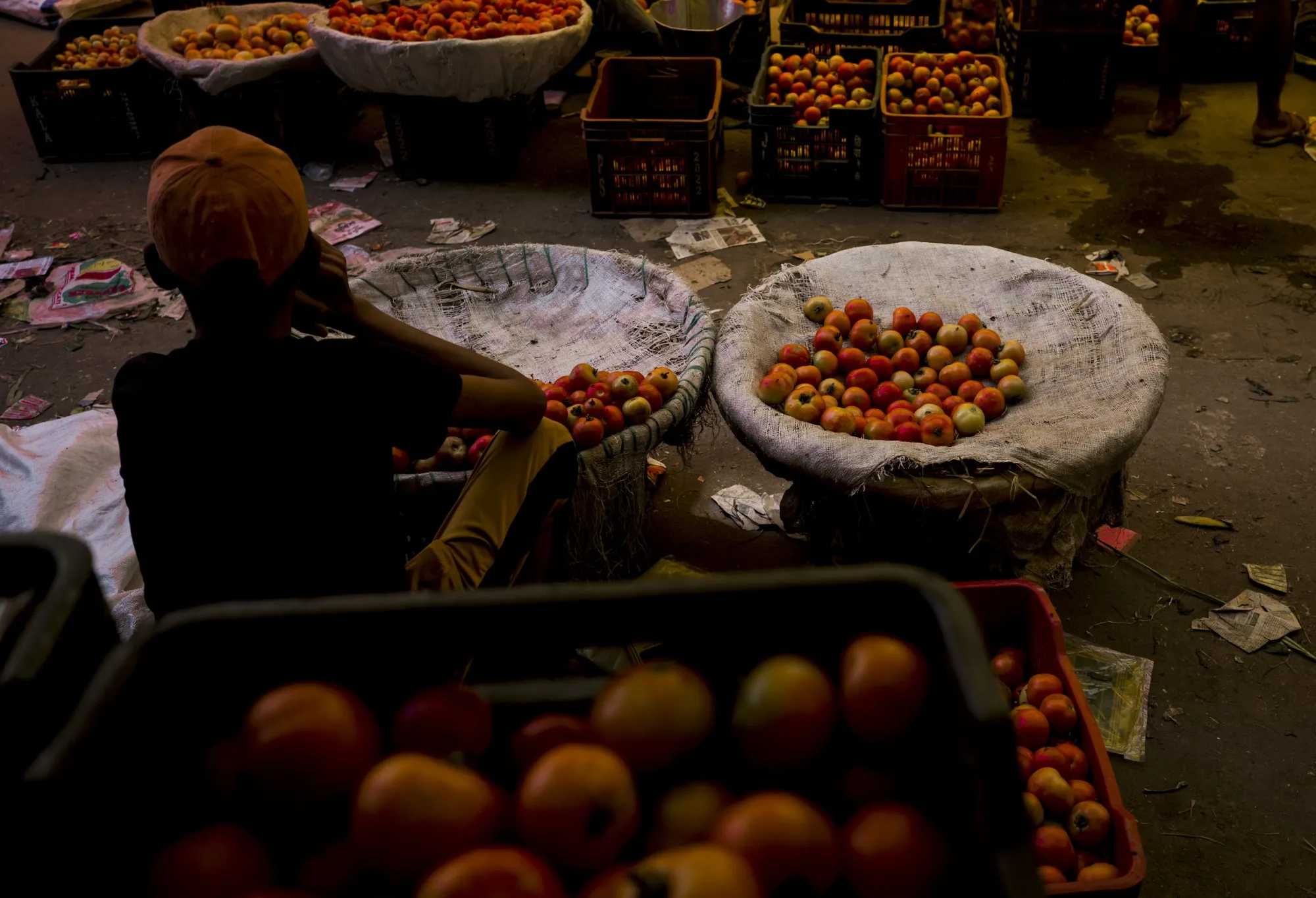 A vendor sells tomatoes at the Azadpur wholesale market in New Delhi.