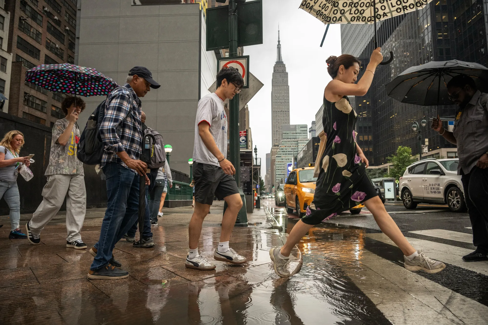 Pedestrians during a rainstorm in New York on Thursday.