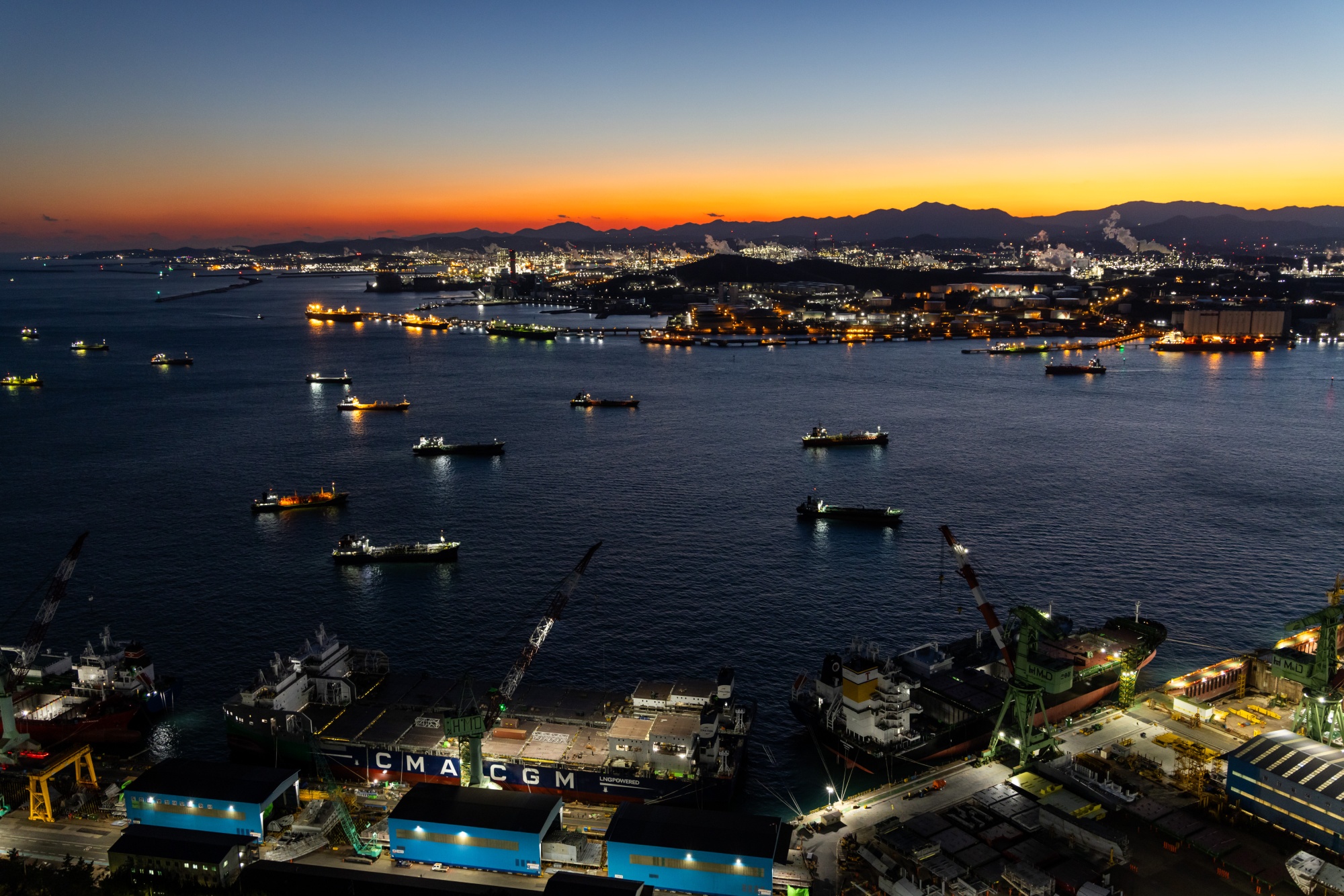 Tankers moored on the sea at dusk in Ulsan, South Korea, on Wednesday, Jan. 24, 2024. South Korea’s simmering credit risks weighed on construction activity last quarter, holding economic growth in check even as exports maintained momentum and adding to concerns for President Yoon Suk Yeol ahead of parliamentary elections crucial to his policy initiatives.