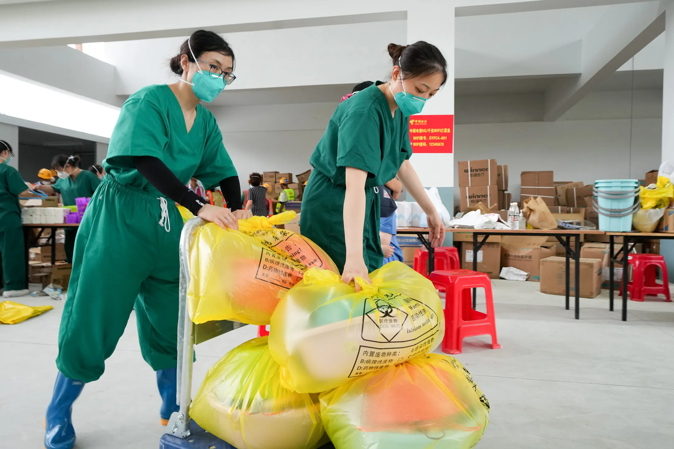 Health workers from Shanghai carry supplies at a Covid-19 makeshift hospital in Sanya on Aug. 16. 