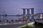 Crowds by the Merlion and Marina Bay Sands in Singapore.&nbsp;