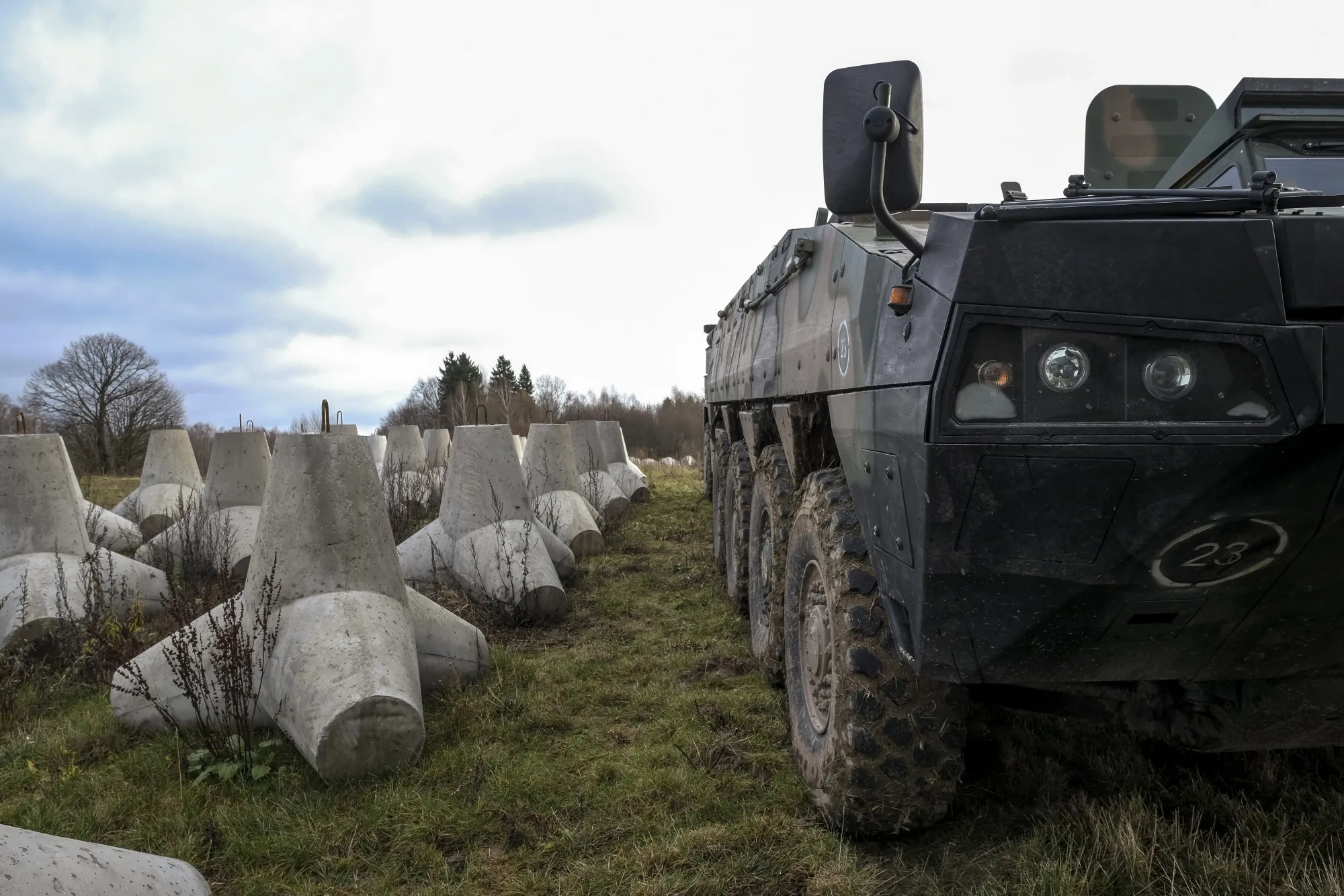 A Polish armored vehicle beside anti-tank defences at the first built part of the East Shield at Poland's border with Russia, in Dabrowka, Poland, on&nbsp;Nov. 30, 2024.