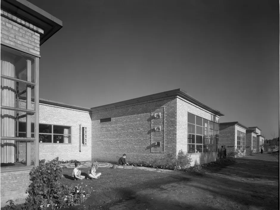 Children sit on the grass at Crow Island shortly after the school opened.