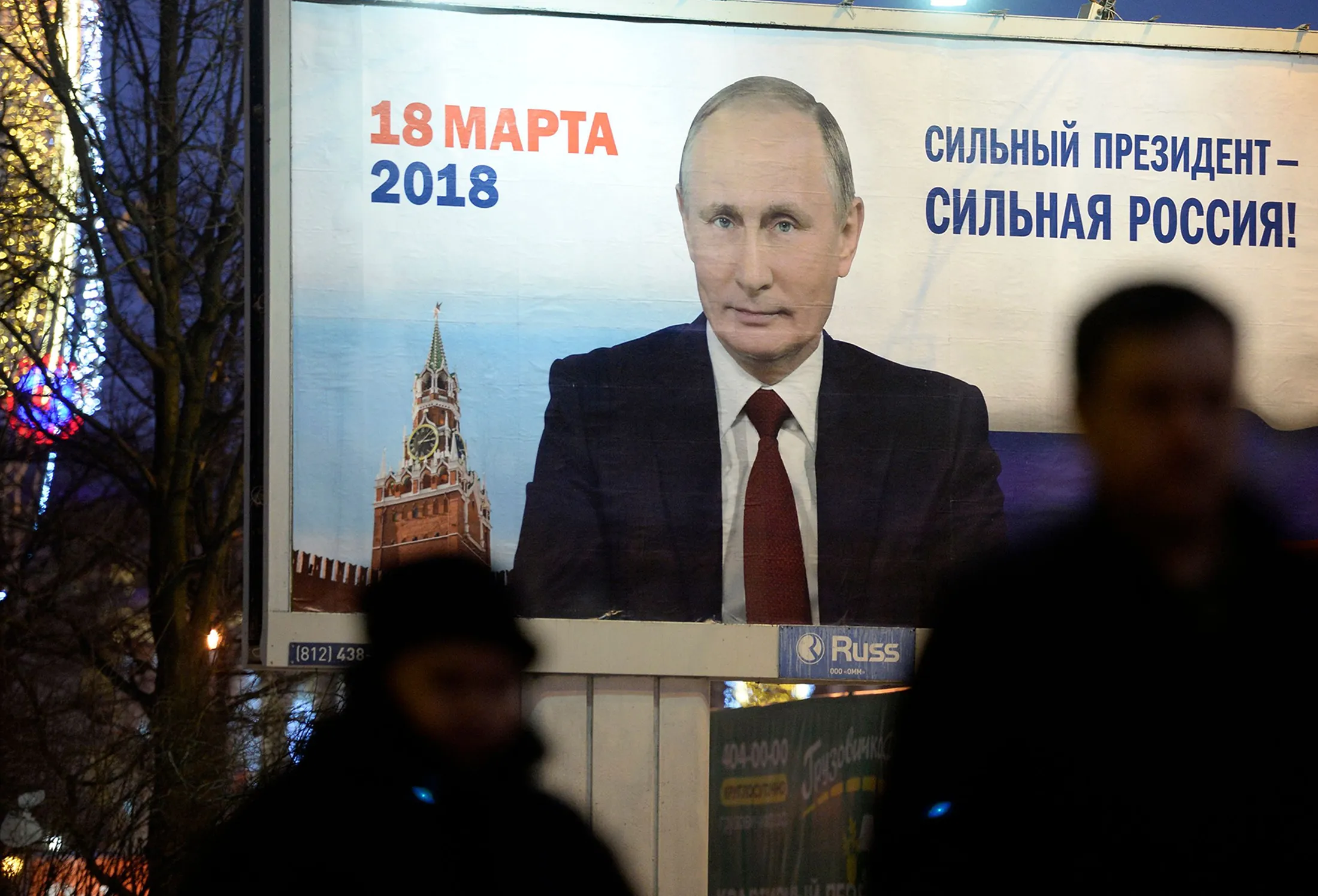 People pass by a billboard with an image of Russian&nbsp;President Vladimir Putin with&nbsp;lettering "Strong president - Strong Russia" in Saint Petersburg on Jan.&nbsp;12, 2018.&nbsp;