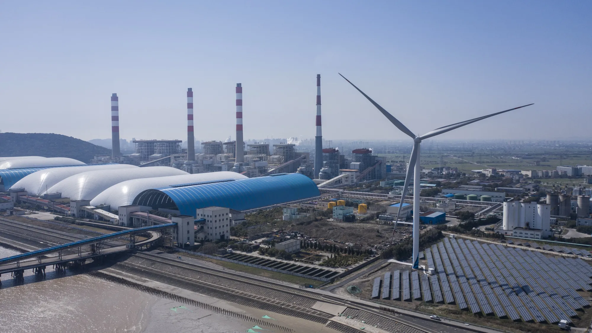 Photovoltaic panels at a solar farm and wind turbines near a coal fired power station in Jiaxing, China, earlier in March.