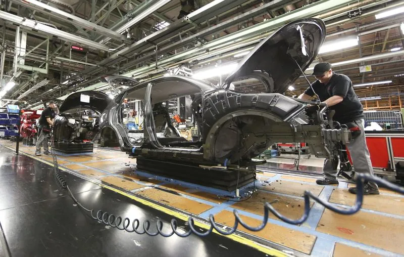 Employees work on new Nissan Qashqai SUV on the production line in Sunderland.