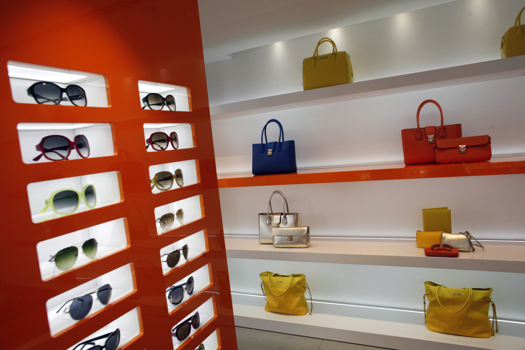 Women's sunglasses and handbags sits on display inside a Folli Follie SA store in the Glyfada district of Athens.