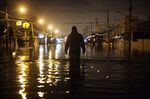 A man wades through flood waters&nbsp;in the Staten Island borough of New York in 2012.