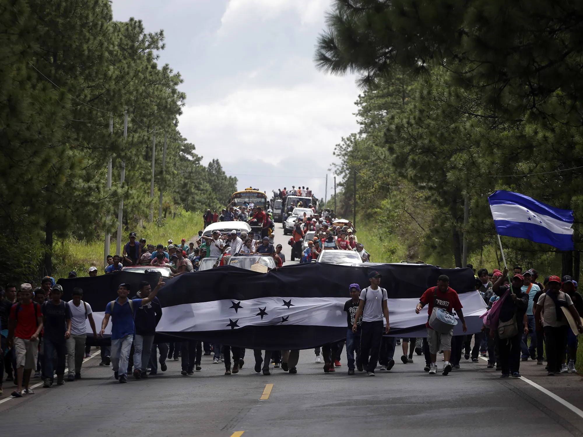 Hondurans march in a caravan of migrants toward the country’s border with Guatemala on Oct. 15.