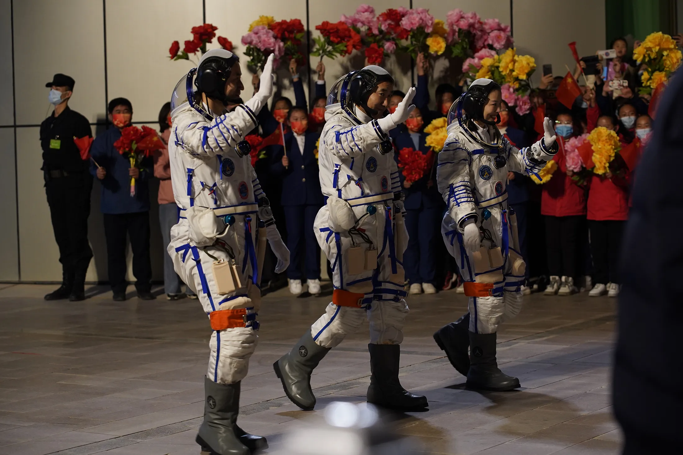 Chinese astronauts wave during a see-off ceremony at the Jiuquan Satellite Launch Center in Jiuquan, Gansu Province,&nbsp;China, on Oct.&nbsp;15, 2021.