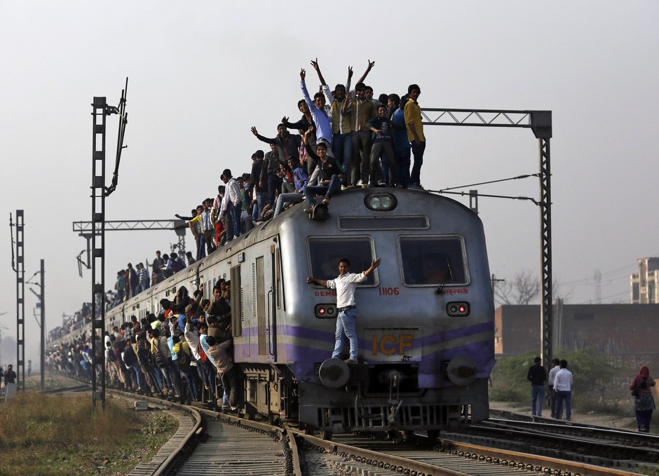 Passengers travel on an overcrowded train on the outskirts of New Delhi.