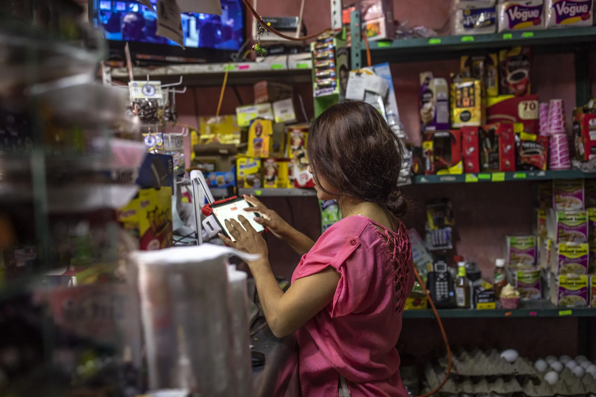 An employee uses the CoDi electronic purchase system at a store in Tulancingo, on Sept. 25.