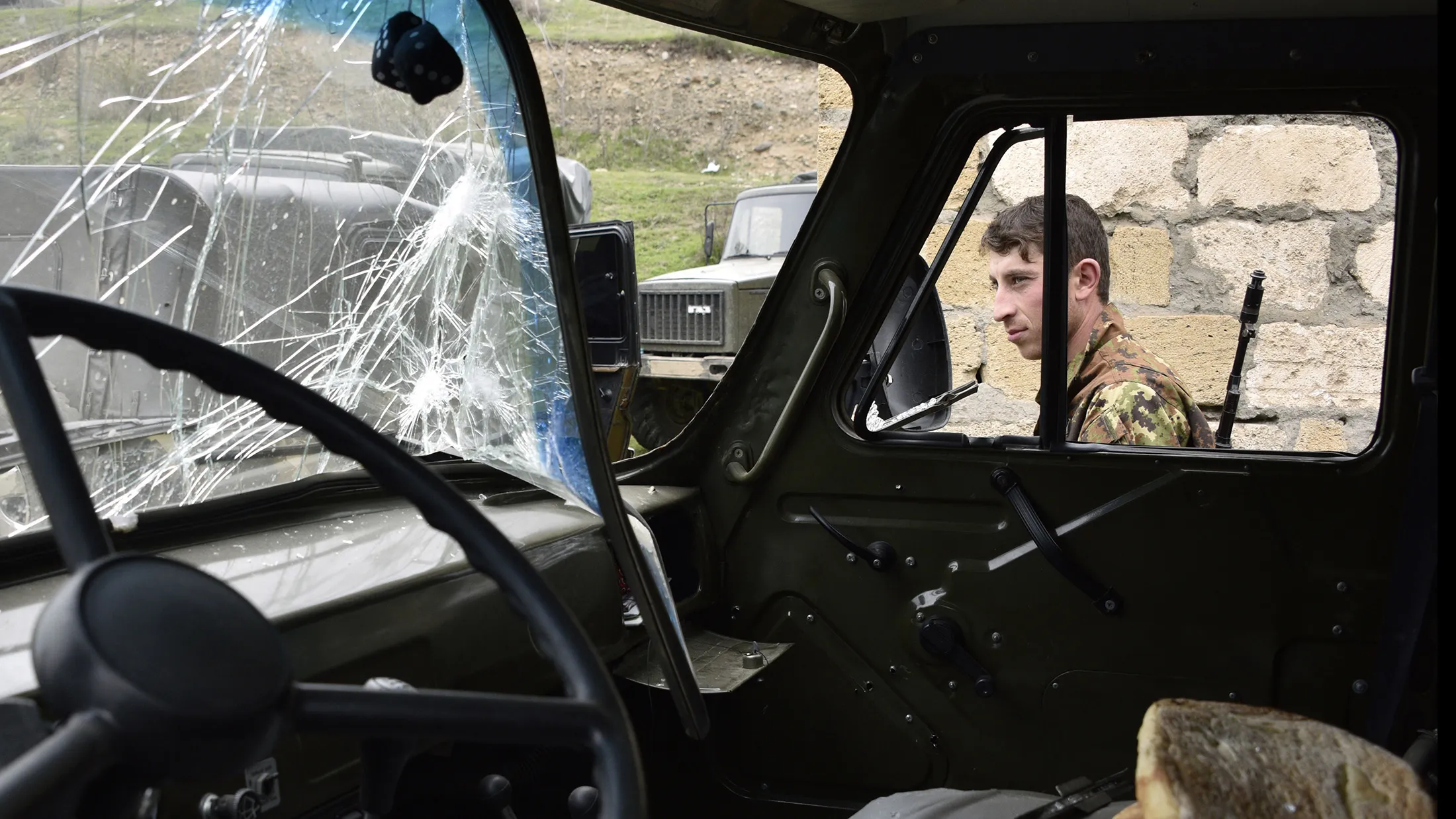 A soldier of the defense army of Nagorny Karabakh walks past a damaged military vehicle in the village of Talish, some 80km north of Karabakh's capital Stepanakert, on April 6, 2016. The global community must recognise the right of the disputed Nagorny Karabakh region to determine its own future, Armenian President Serzh Sarkisian said on April 6 after four days of deadly clashes that unsettled the West. / AFP / KAREN MINASYAN (Photo credit should read KAREN MINASYAN/AFP/Getty Images)

