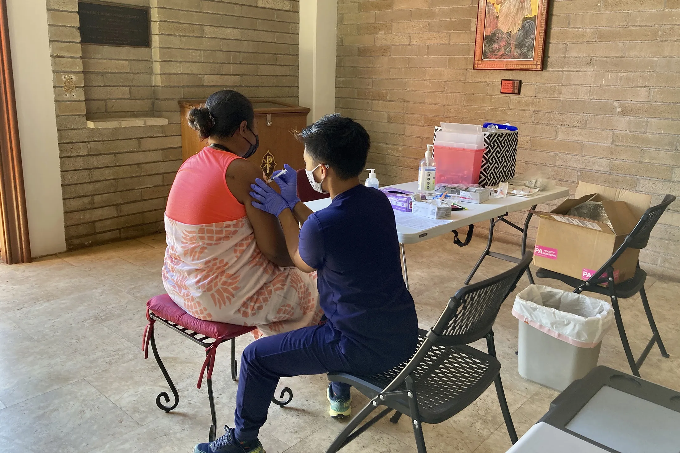 A healthcare worker with Project Vision Hawaii administers a Covid-19 vaccine dose to at a clinic in Honolulu on July 14.