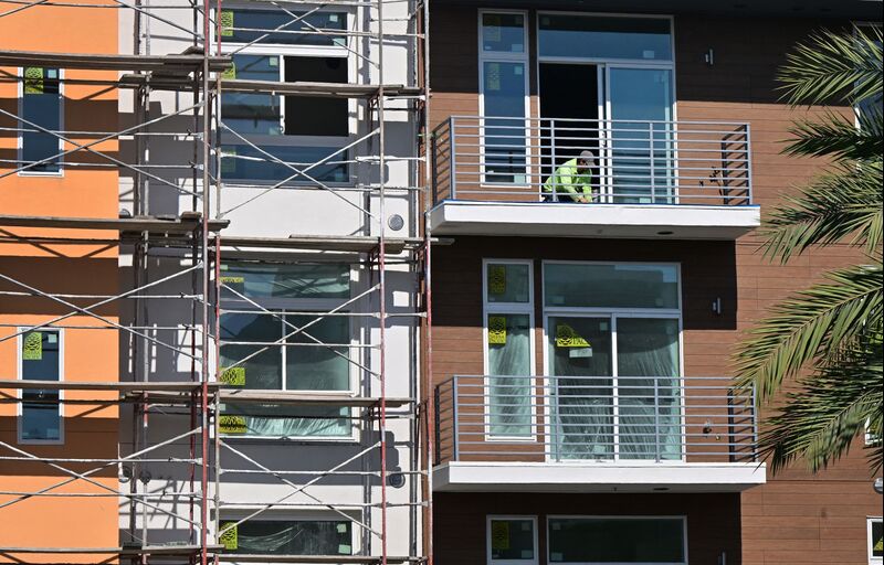 A construction worker works on the balcony of a nearly completed new apartment complex in Alhamba, California on September 6, 2023. With US mortgage rates rising to 15-year highs hovering around 7.2% to start the post-Labor Day period, the difference between new 30-year home loan rates and on all outstanding US mortgage debt has not been this wide since the 1980s. (Photo by Frederic J. BROWN / AFP) (Photo by FREDERIC J. BROWN/AFP via Getty Images)