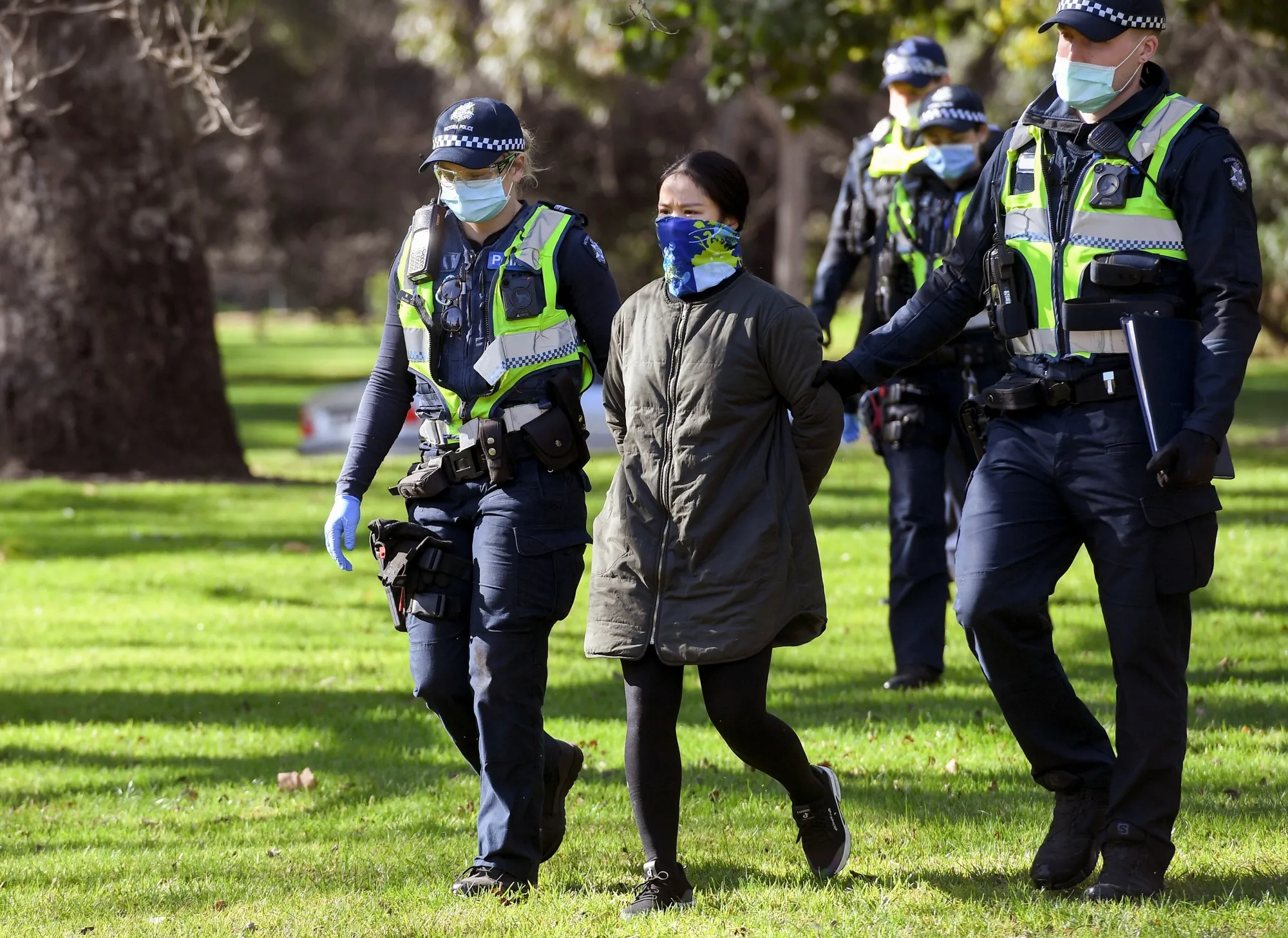 Police detain an anti-mask protester in Melbourne on July 31.