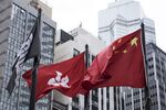 The Chinese and Hong Kong national flags near the Hong Kong Stock Exchange.