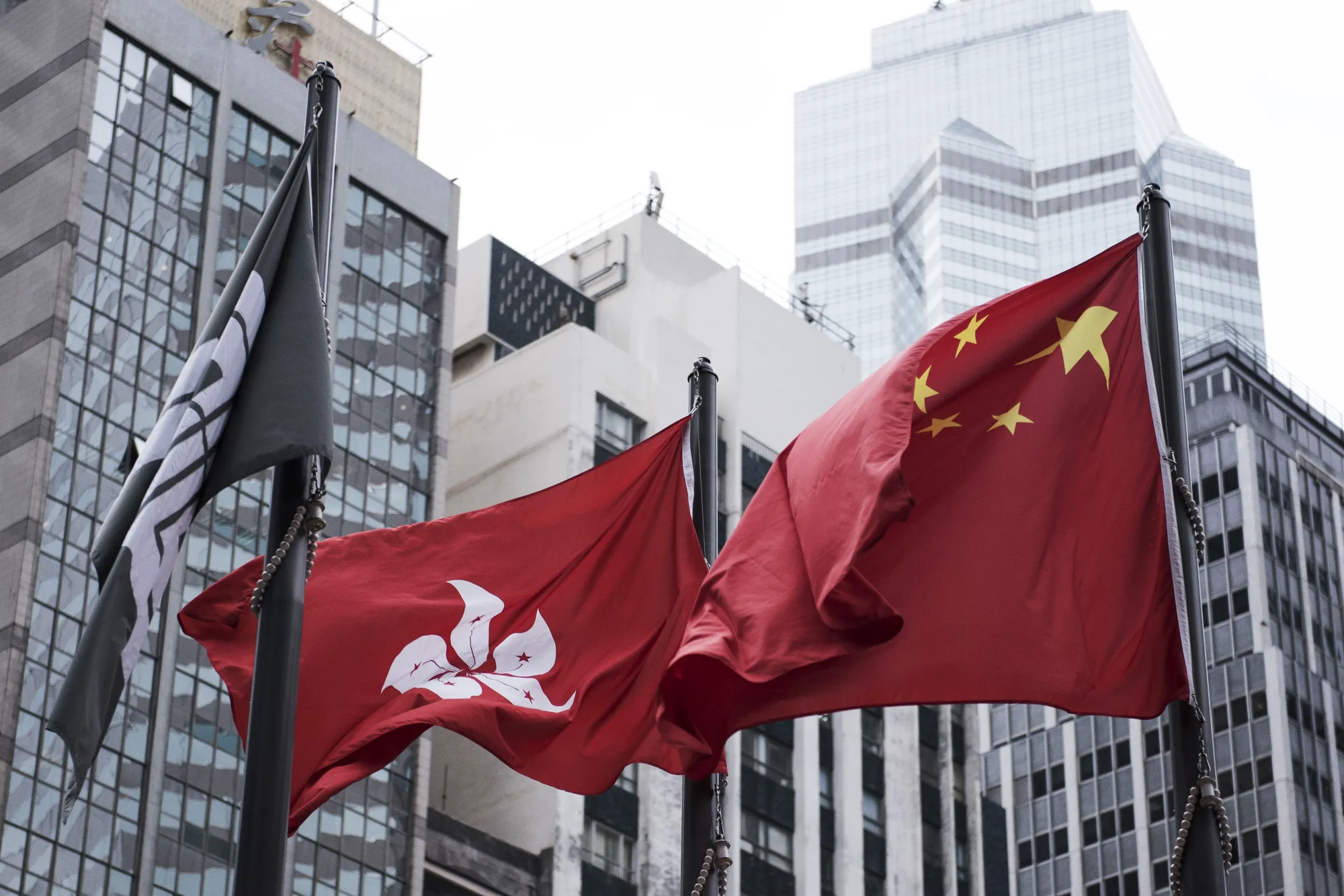 The Chinese and Hong Kong national flags near the Hong Kong Stock Exchange.