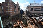 A resident walks past destroyed houses in the village of Russkiye Tishki in the north of Kharkiv region of Ukraine on March 27.
