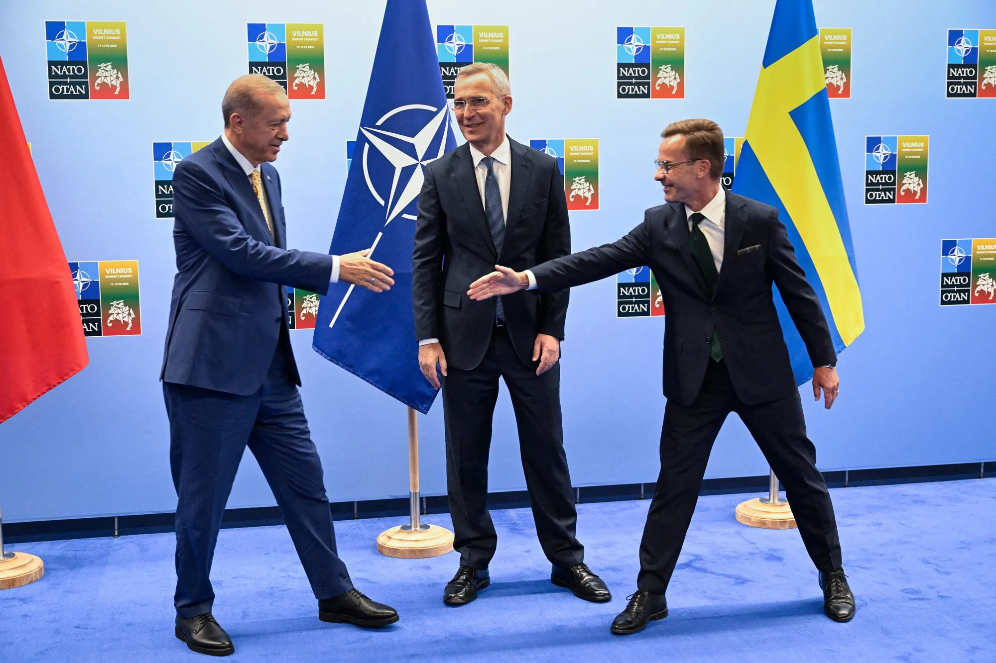Turkish President Recep Tayyip&nbsp;Erdogan and Swedish Prime Minister Ulf Kristersson shake hands next to NATO Secretary-General Jens Stoltenberg&nbsp;in Lithuania on Monday.&nbsp;