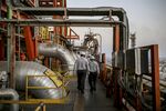 Employees walk through the Vadinar Refinery complex jointly owned by Rosneft Oil Co. and Trafigura Group Pte., near Vadinar, India.