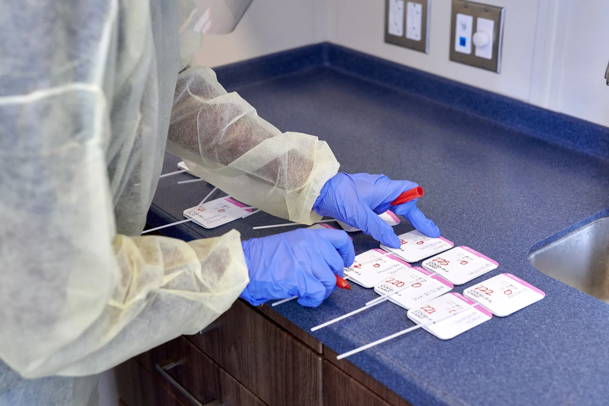 A healthcare worker conducts a Covid-19 rapid test at a drive through testing site in Cruz Bay, Saint John, U.S. Virgin Islands.