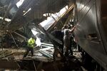 Train personnel survey the NJ Transit train that crashed in to the platform at the Hoboken Terminal on Sept. 29, in Hoboken.
