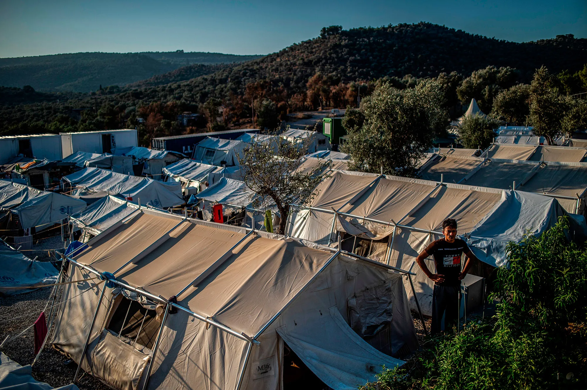 A migrant stands&nbsp;amid tents at a refugee camp on the Greek island of Lesbos.&nbsp;