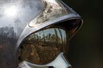 Trees scorched by wildfires reflected in a firefighter’s helmet in a forest near the village of Louchats in Gironde, France, on Thursday, July 21, 2022.&nbsp;