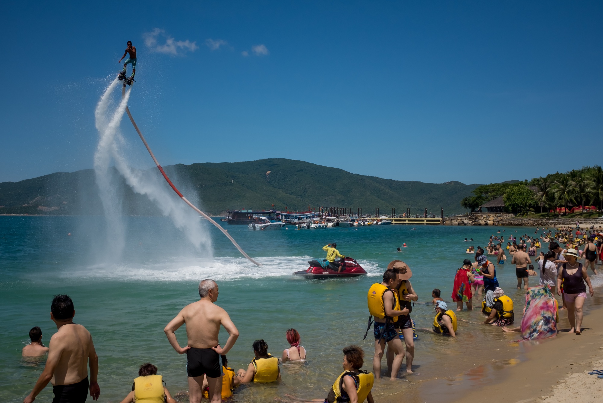 Chinese tourists watch the flyboard show by the beach of Hon Tam Resort in Nha Trang, Vietnam.