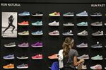 A customer browses a wall of Nike Inc. sneakers on display for sale at Dick's Sporting Goods Inc. store in Sterling Heights, Michigan, U.S., on Thursday, Aug. 18, 2016.