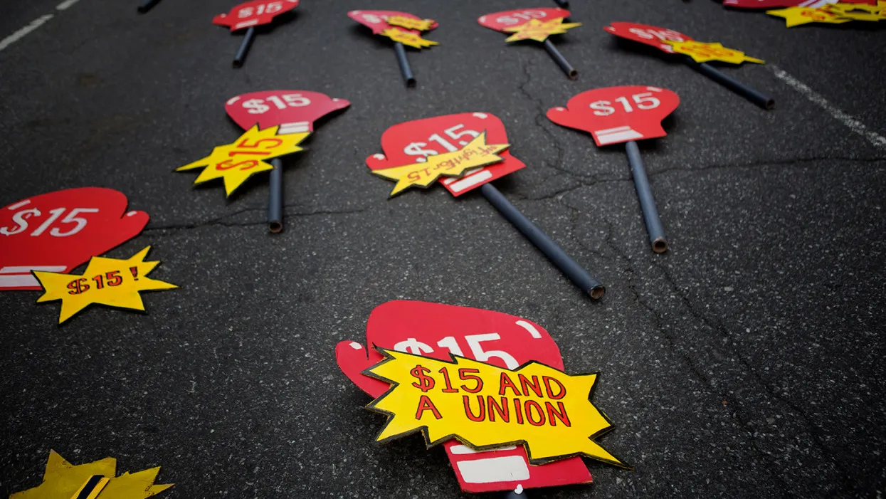 Signs lay in the street before the start of a rally in support of minimum wage increase in New York, U.S., on Wednesday, April 15, 2015.
