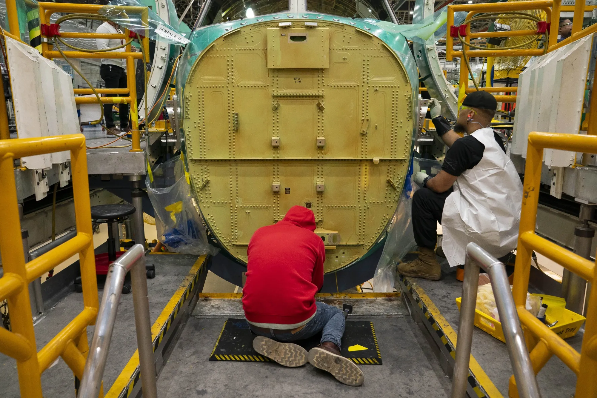 Workers on the assembly floor at a airplane manufacturing facility in Renton, Washington.