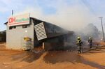Firefighters extinguish a fire at a supermarket in Manzini, Eswatini, on June 30.