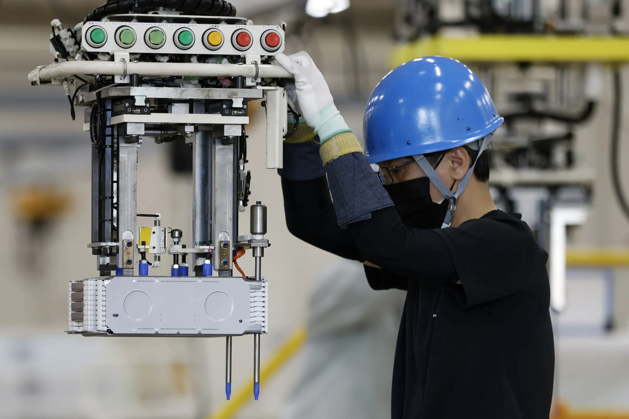 A worker moving&nbsp;a lithium-ion battery pack&nbsp;for an electric vehicle at a Mitsubishi Motors&nbsp;plant last month in Kurashiki, Japan.
