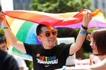 A man holds a rainbow flag after taking part in the Pride Run in Shanghai.&nbsp;
