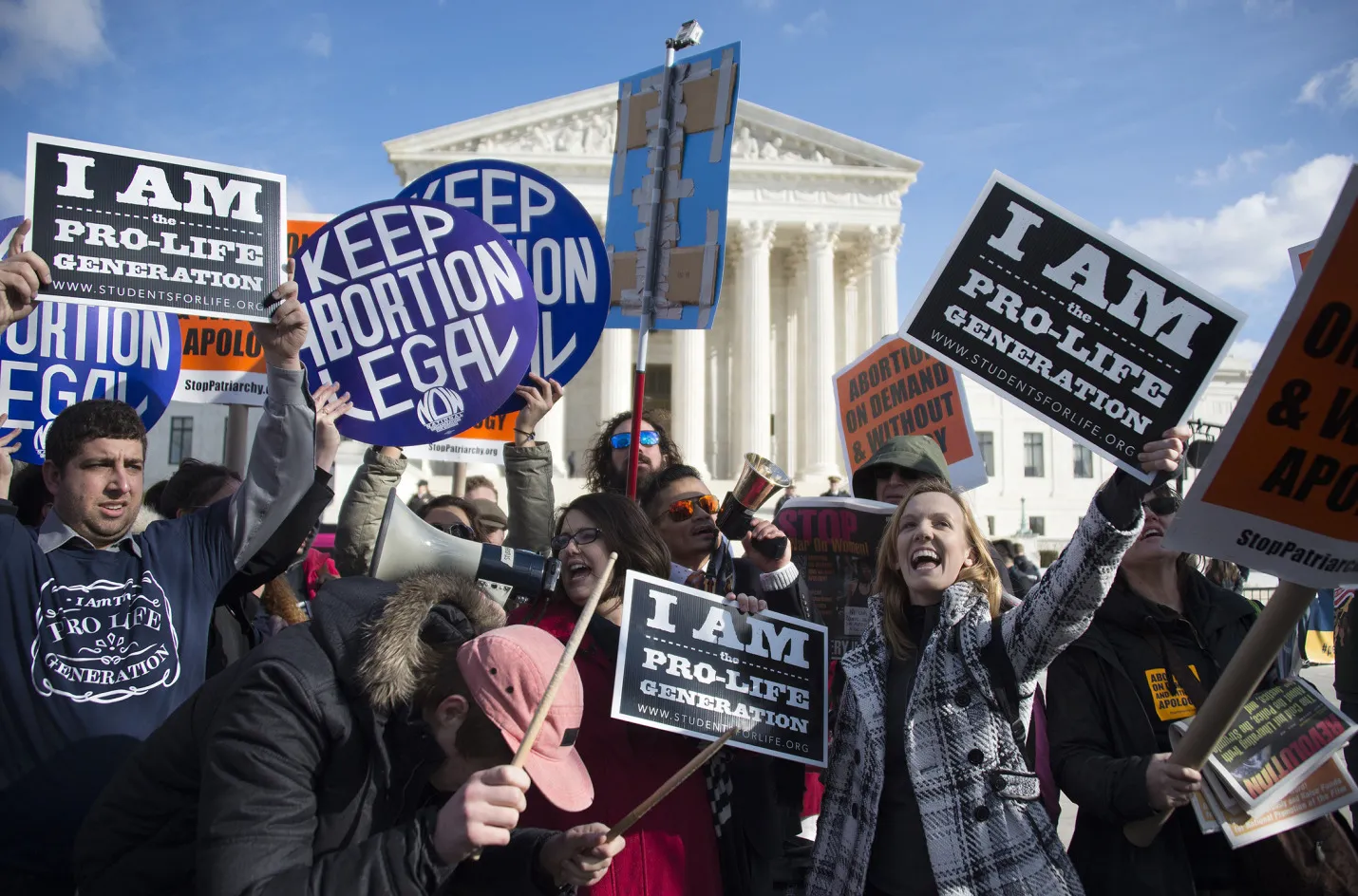Pro-choice and pro-life activists stand in front of the US Supreme Court in Washington, DC.
