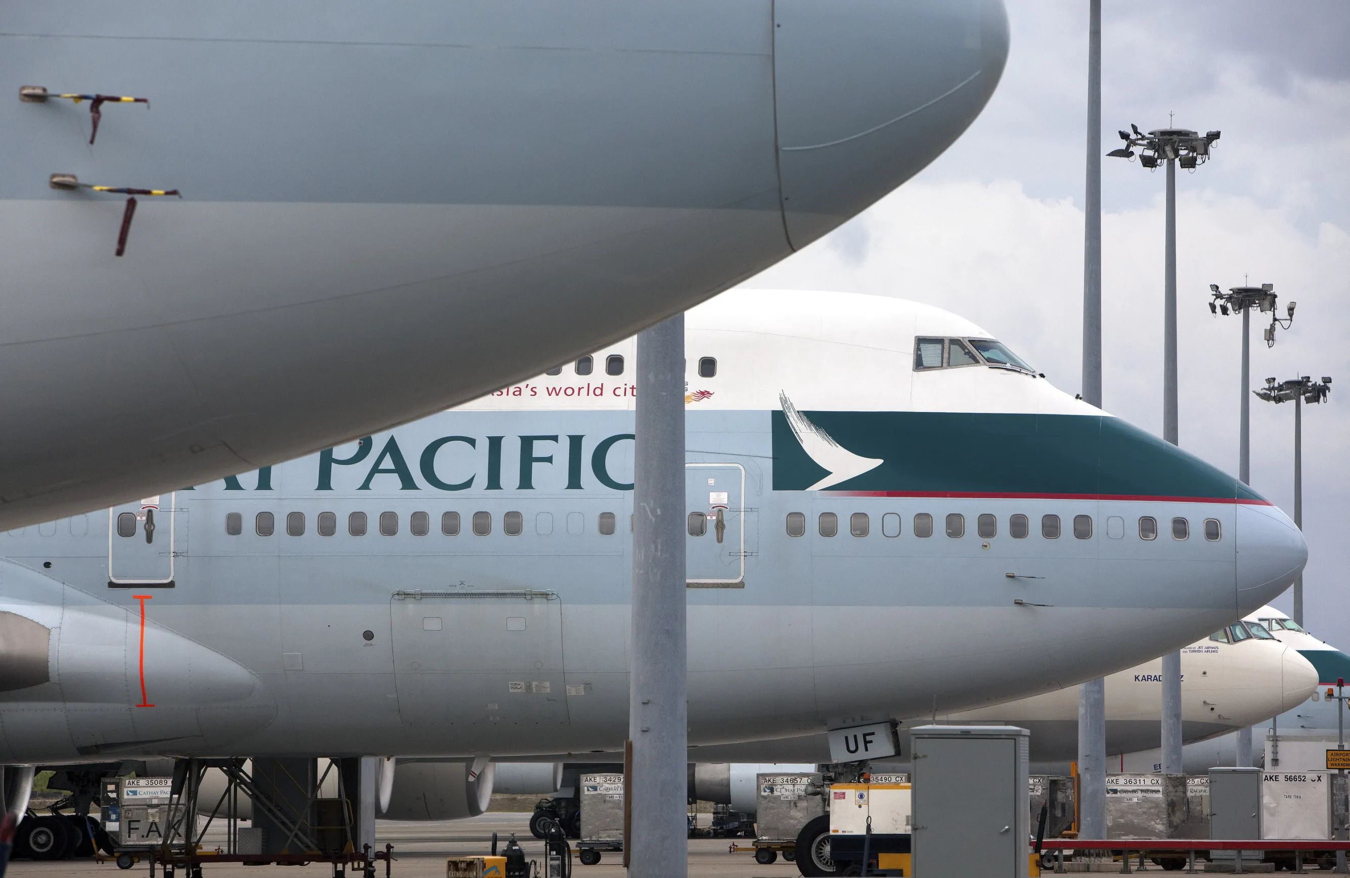Cathay Pacific Airways Ltd. planes are parked at the Chek Lap Kok International Airport in Hong Kong, China, on Friday, July 3, 2009. The rise in jet fuel price this year may help Hong Kong's Cathay Pacific and Air China trim paper losses from wrong-way bets on oil.