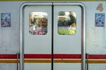 Passengers ride onboard a train at a railway station in Jakarta.