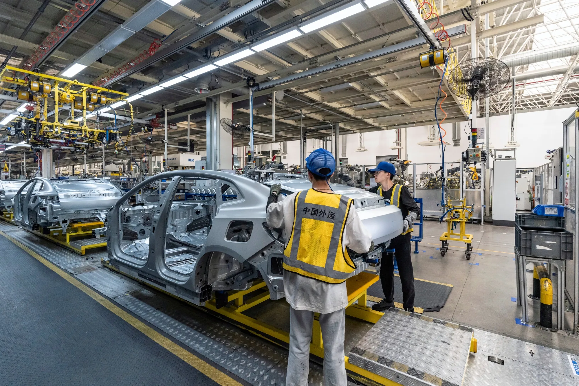 Employees on the body shop floor at the Zeekr Group Intelligent Factory in Ningbo, China.