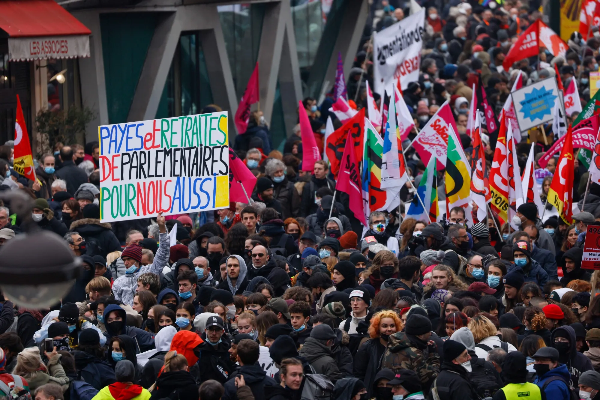 Protestors hold banners and trade union&nbsp;flags during a protest&nbsp;in Paris in January 2022.&nbsp;