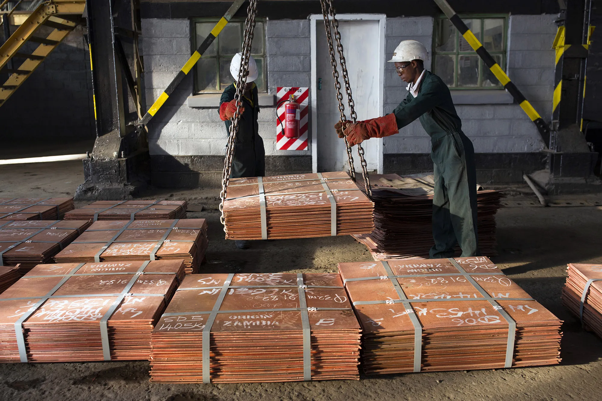 Workers load batches of copper sheets in Zambia.