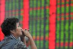 A Chinese investor looks at prices of shares at a stock brokerage house in Fuyang city, east China's Zhejiang province on Aug. 28&#13;
Zhejiang province on Aug. 28&#13;
